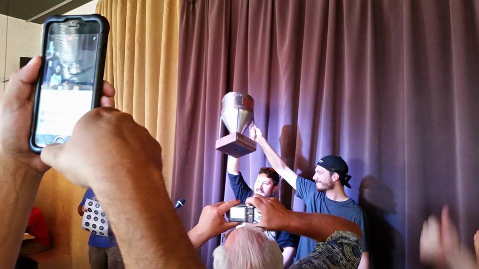 Amid a sea of people taking pics on their cell phones, the Boxing Bear brewing team holds their NMIPAC trophy aloft!